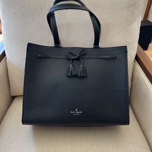 Black pebbled leather Kate Spade tote with tassel bow detail.